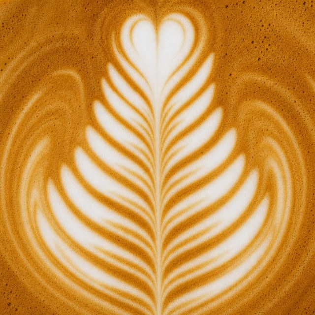 GrabMe flat white with rosetta latte art, seen from above